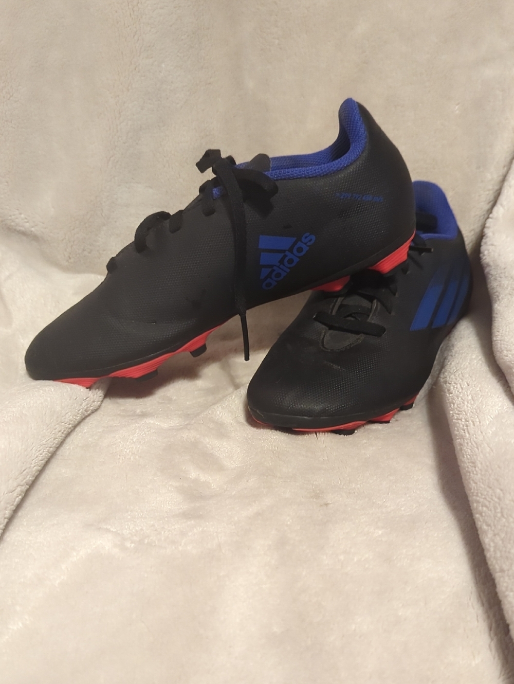 adidas Black Soccer Cleats with Blue Logo and Red Outsole